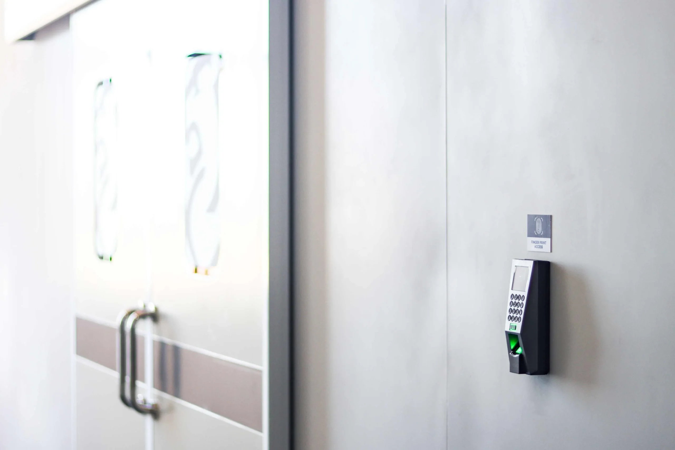 Fingerprint access reader at an assembly room door inside Shield Works