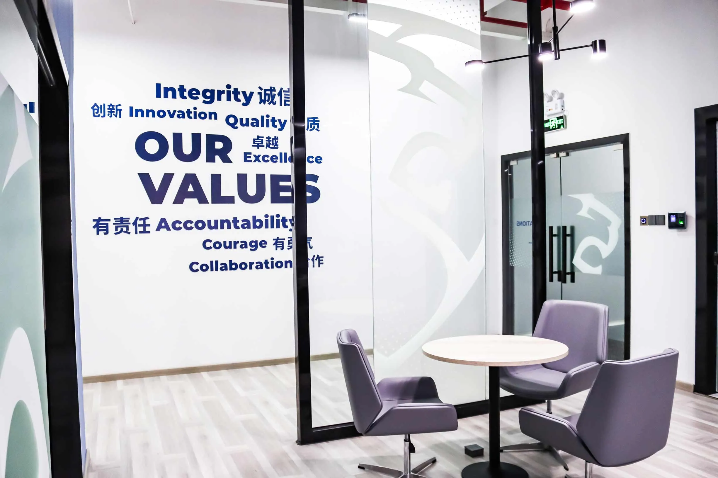 Shield Works team members in front of the Our Values wall at the Zhuhai facility