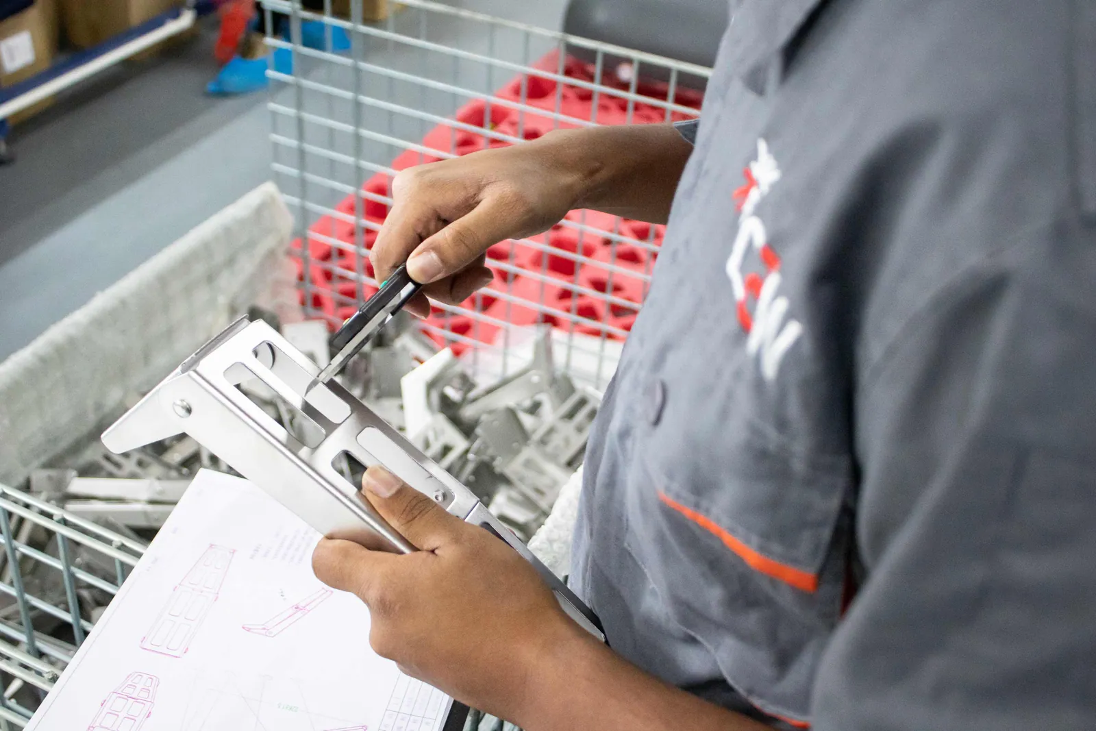 Quality engineer recording inspection results against a checklist at Shield Works in Zhuhai