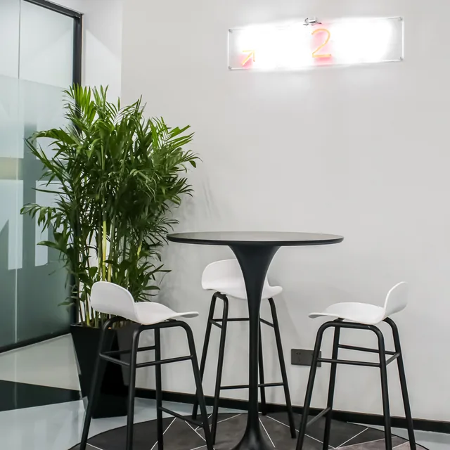An informal meeting area at the C2W Group office with high tables and stools