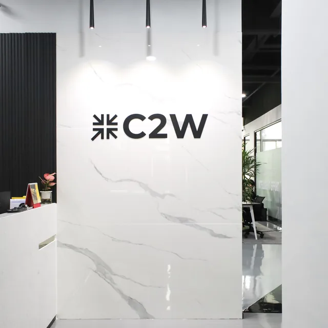 The C2W reception area, with the C2W mark mounted on a marble wall
