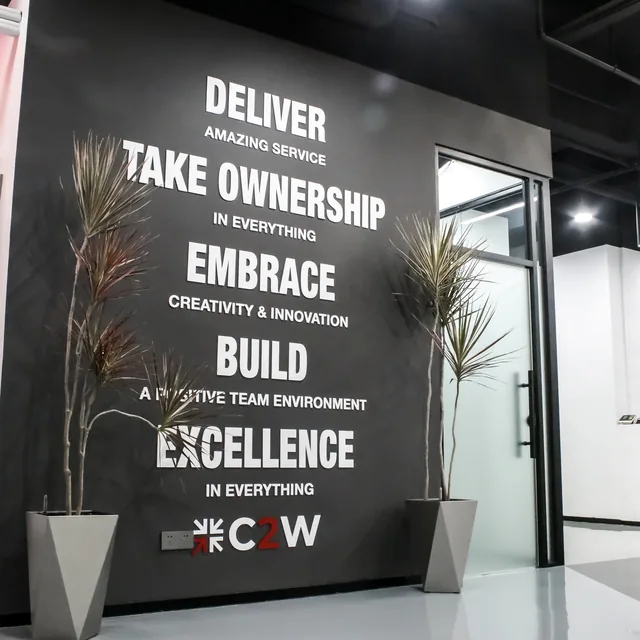 The C2W Group values wall reading deliver, take ownership, embrace, build, excellence