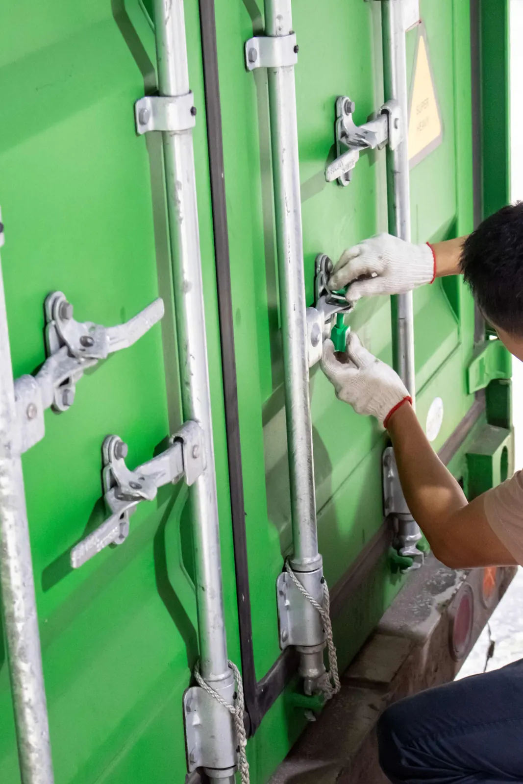 A team member sealing the container doors before dispatch