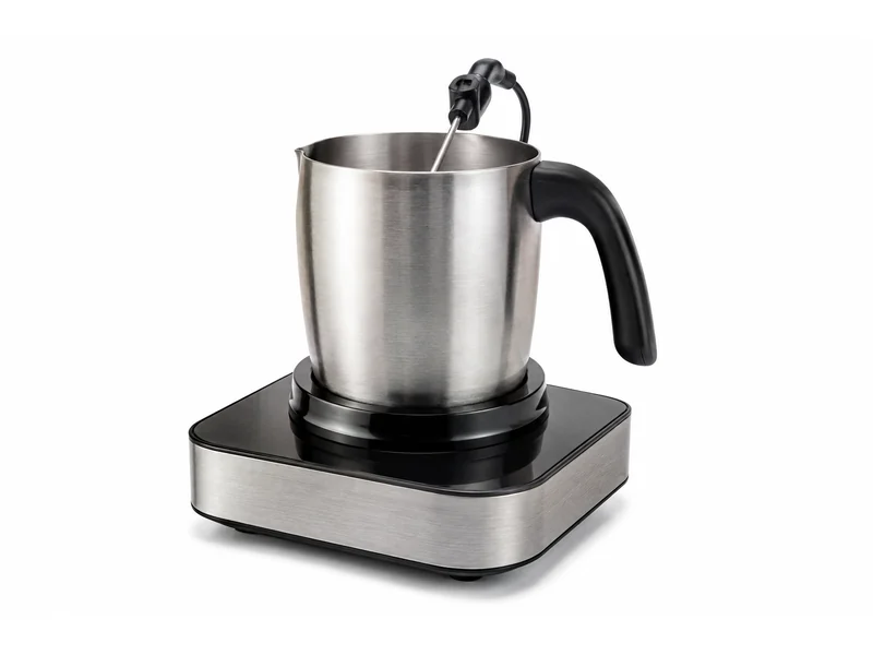 Stainless steel milk frothing jug on an induction frother base