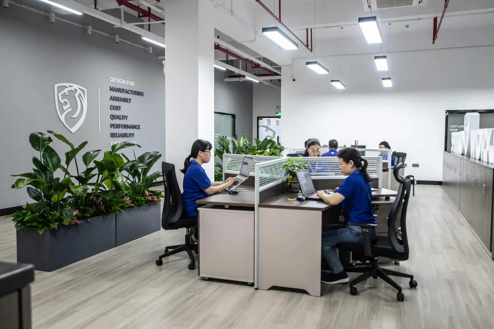 Engineers at their desks across the open-plan DFX office in Zhuhai