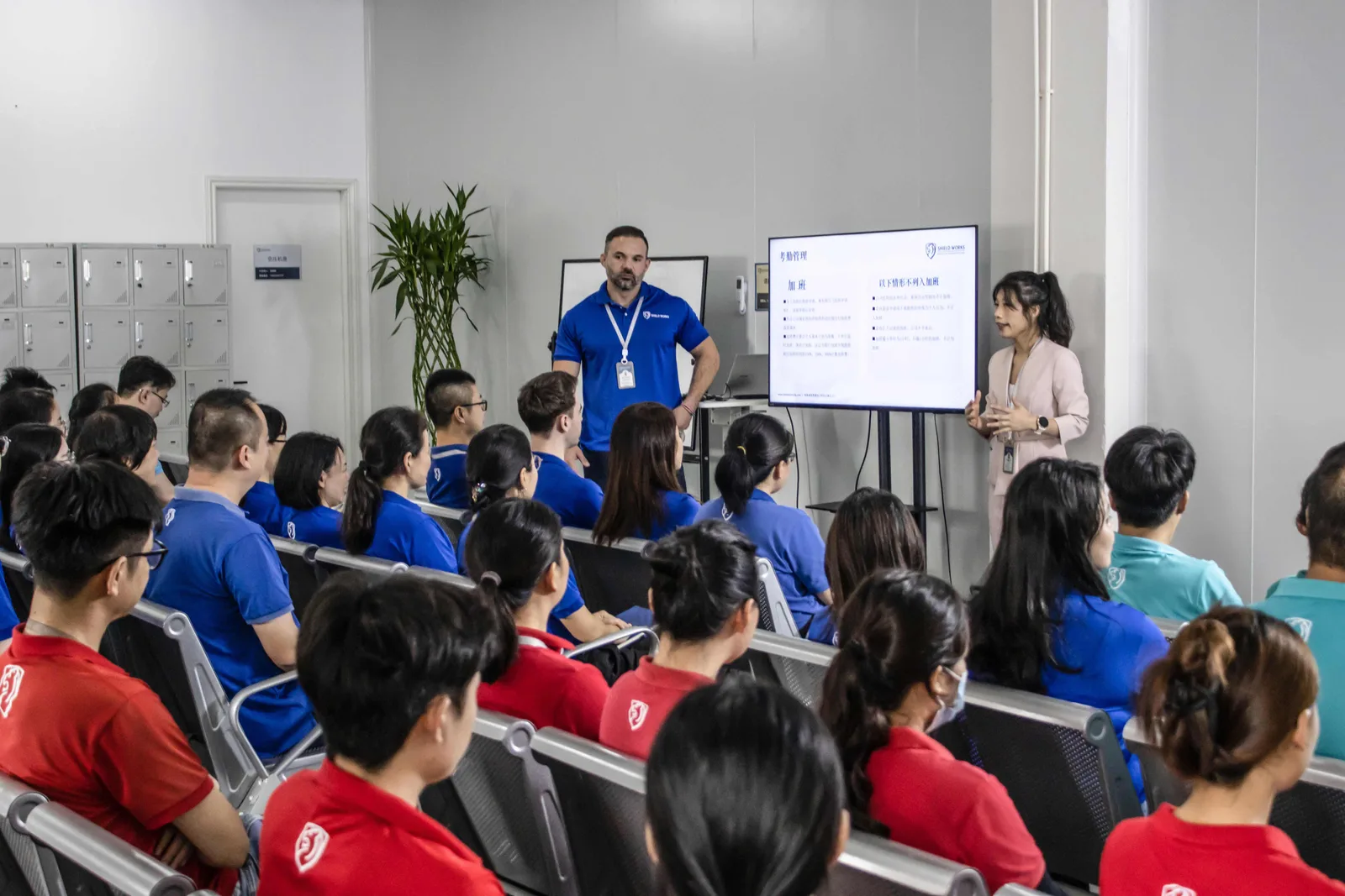 A presenter leading a structured development session for a room of Shield Works staff
