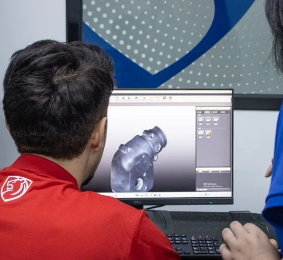 An engineer reviewing 3D scan data of a part against its model