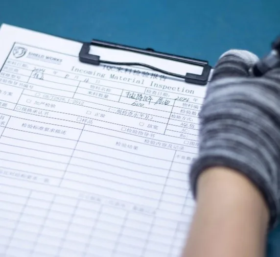 An incoming material inspection record being completed