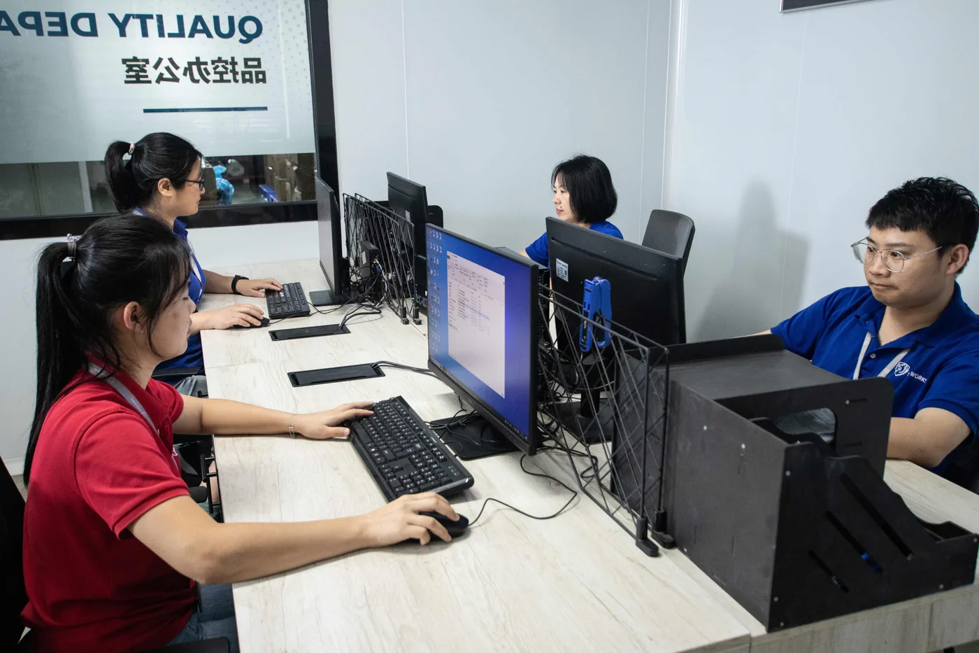 Shield Works Quality Department staff working at computer workstations